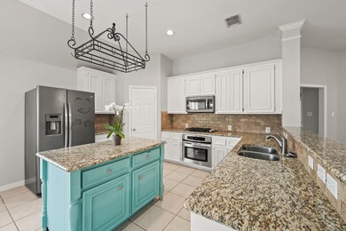 Perry Homes kitchen with a hanging pot rack, gas stove and walk in pantry. 
 Refrigerator included.
