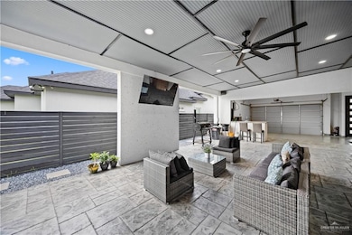 View of patio with ceiling fan, outdoor lounge area, and an outdoor bar