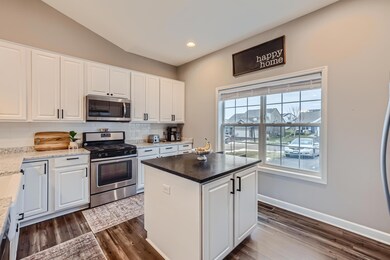 Center island features a black matte quartz countertop, storage on one side, garbage on the other. The large windows makes it light and bright year round