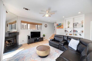 Living room featuring recessed lighting, a lit fi