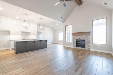 Kitchen with ceiling fan, a center island with sin