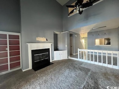 Unfurnished living room with carpet, ceiling fan, 