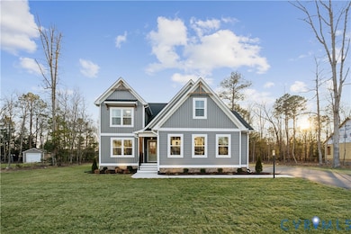 Craftsman house featuring a front yard, board and batten siding, and an outdoor structure