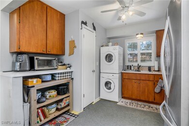Clothes washing area featuring dark colored carpet