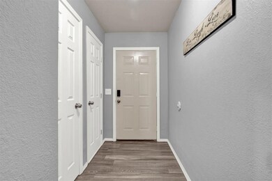 Doorway to outside featuring dark wood-type floori