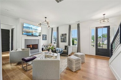 Living area featuring an inviting chandelier, base