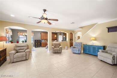 Living area with crown molding, a ceiling fan, and