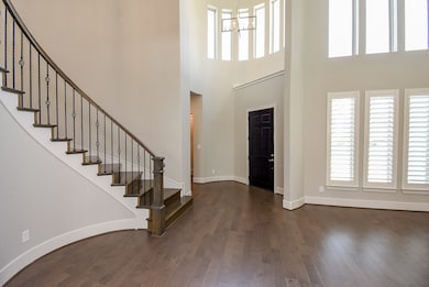Stunning hard wood floors, floor to ceiling windows and a sweeping staircase welcome you inside.