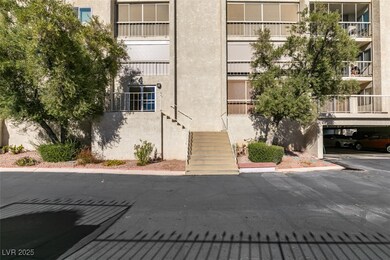 View of building exterior with covered parking