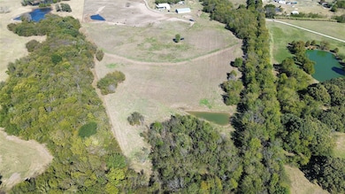 Aerial view of property's location with a large body of water