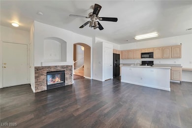 Kitchen with light brown cabinets, black appliance