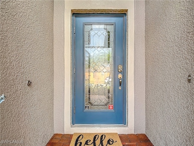 Entrance to property with stucco siding