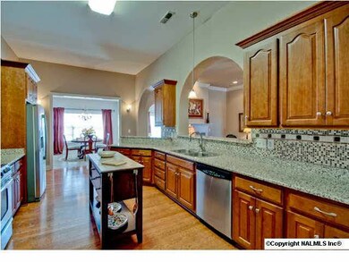 Just imagine creating those culinary delights in such an elegant huge kitchen. There's enough countertop space to spread out. The open floor plan and arched pass through keeps you from feeling cut off from all the action.