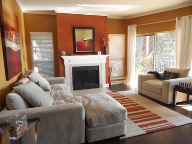 Living room with a fireplace, ornamental molding,