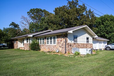 This is a side view of the home showing the attached three bay garage/workshop.