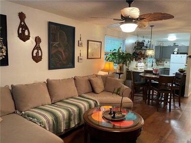 Living room with view into kitchen.