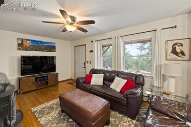 Cozy and inviting, the living room centers around a wood-burning fireplace—perfect for cool mountain nights.