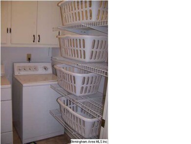 Main Level Laundry room w/ cabinets & shelves