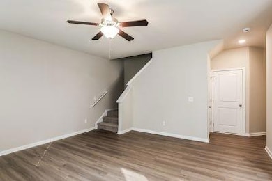 Unfurnished living room with baseboards, ceiling f