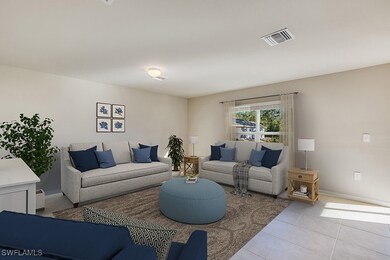 Living area with light tile patterned floors and b