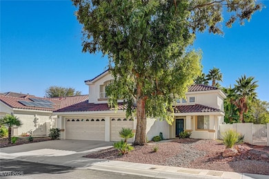 Mediterranean / spanish home with driveway, stucco siding, and a tile roof