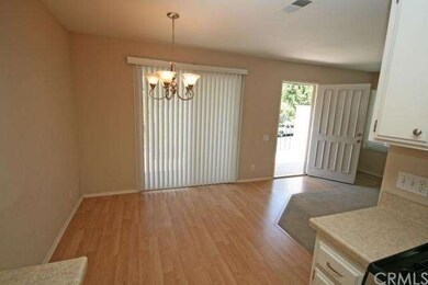 This picture looks back from the kitchen through the dining area to the front door
