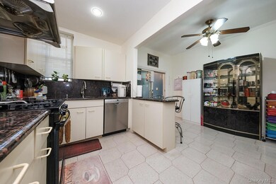 Kitchen featuring exhaust hood, a kitchen breakfast bar, backsplash, a peninsula, and black gas stove