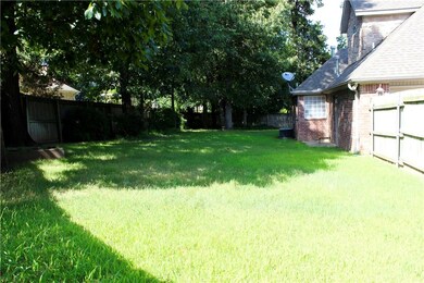 Spacious fenced-in backyard with professional landscaping.