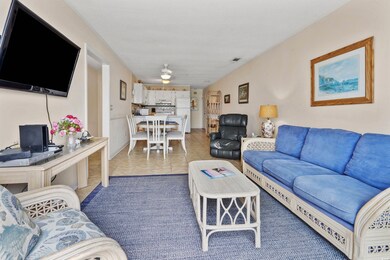 Living room featuring ceiling fan and light tile patterned floors