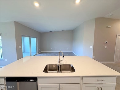 Kitchen featuring dishwasher, a sink, open floor p