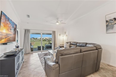 Tiled living room with ceiling fan and ornamental molding