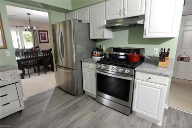The kitchen has white cabinets, granite countertops and a luxury vinyl floor. A gas hookup allows for a gas range. The range and refrigerator do not stay.