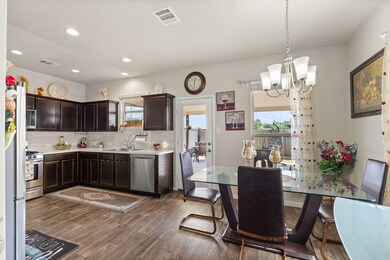 From the living area, step into the kitchen featuring stainless steel appliances, a pantry, and a bright breakfast area with lots of windows.