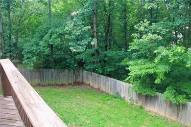 Large fully fenced backyard with gate.
