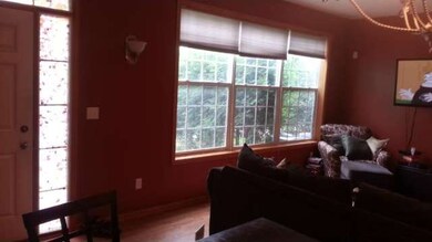 Living room picture windows looking out to small p