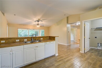 Kitchen featuring dishwasher, a sink, ceiling fan,