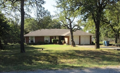 Single story home featuring a front yard and brick siding