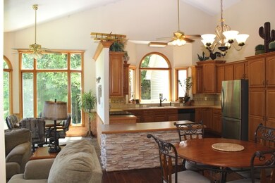 Large kitchen with Teak hardwood plank flooring