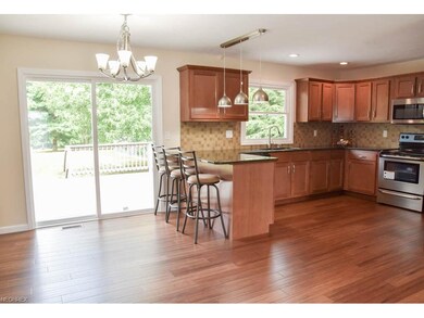 Kitchen has a breakfast bar and stainless steel ap