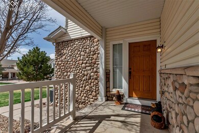 Property entrance with a porch and stone siding