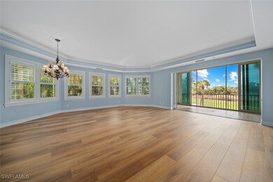 Empty room with a notable chandelier, a raised cei
