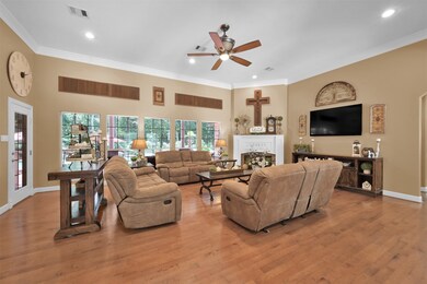 The den is accentuated by large windows that allow natural light to fill the space.