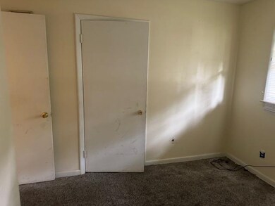 Unfurnished room featuring dark colored carpet