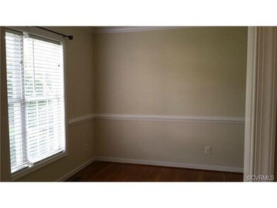 Dining room with chair rail and crown moulding.