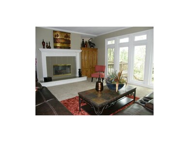 Great Room Fireplace Overlooking Deck and Wooded A