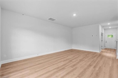 View of entry, office/flex space from living room. Luxury vinyl plank flooring.
