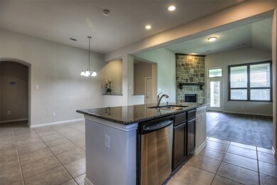 Looking out from the kitchen to the breakfast area and the family room. The hall to the left leads to two secondary bedrooms downstairs and a full bath.