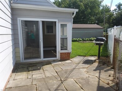 Exit from breezeway to sandstone patio with built-in gas grill