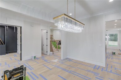 Unfurnished dining area with stairs, a chandelier,