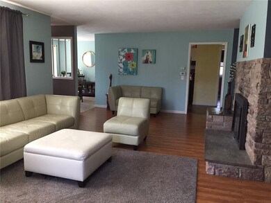 The spacious living room has a woodburning firepla
